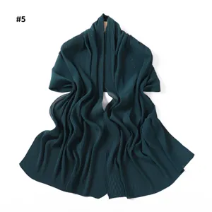 Detailed close-up view of dark green pleated shimmer chiffon scarf, soft textured design.