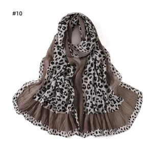 Detailed view of women pleated leopard print long scarf, soft breathable fabric texture.