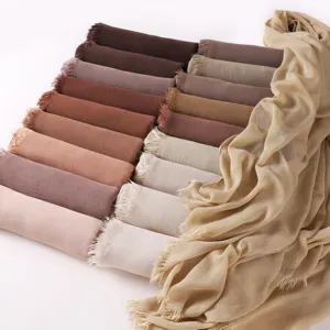 Detailed view of soft crinkled rayon long scarf in earth tones with stylish fringe ends.