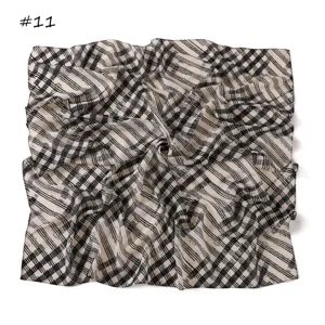 Close-up detail of black and white printed chiffon square scarf vintage plaid style.