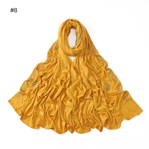 Yellow mercerized cotton hijab scarf with shimmering rhinestone paisley wave edge details.