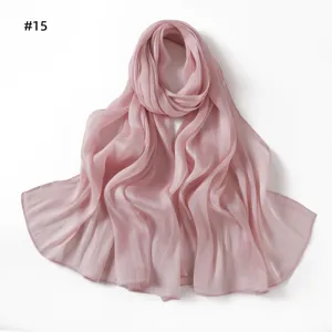 Close-up detail of the pink crinkled satin scarf showing soft texture and glossy drape.