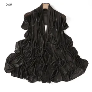 Detailed view of the black mesh shawl featuring sparkling rhinestone star motifs and soft drape.