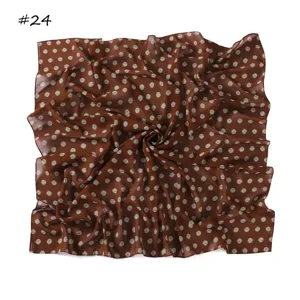 Detail view of a retro brown polka dot chiffon square scarf, lightweight fabric close-up.