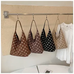 Detailed view of women autumn suede polka dot shoulder tote bag, retro large capacity design.