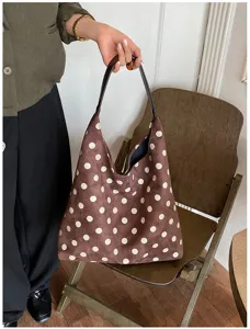 Detailed view of the brown suede polka dot shoulder bag showcasing soft fabric and casual hobo design.
