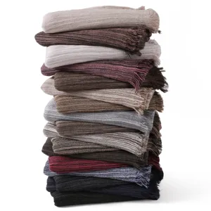 Retro striped tassel scarf detail showing soft textured fabric layers and rich color variations.