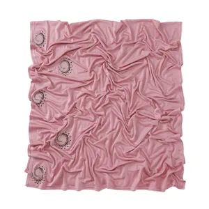 Detailed view of the pink stretchy mercerized cotton scarf with sparkly rhinestone swirls.
