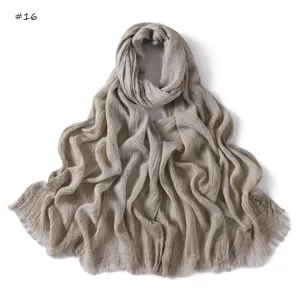 Details of the vintage solid color crinkled cotton long scarf with fringe and subtle texture.