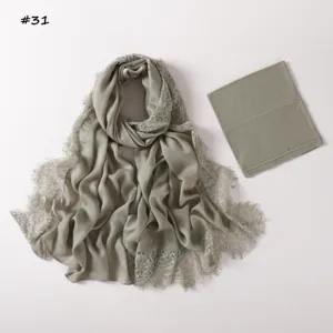 Detail view of the soft modal lace hijab scarf and matching stretch tube cap set in sage green.