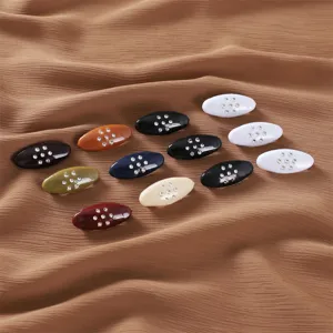 Close up view of colorful oval rhinestone safety pins, anti-glare hijab scarf brooch set.