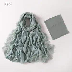 Detailed close-up view of the sage green modal lace scarf and matching inner tube cap set.