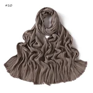 Detailed close-up of the soft pleated brown long scarf texture and fringe craftsmanship.