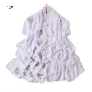 Close-up detail of white chiffon rhinestone rose long scarf shawl, elegant drape design.
