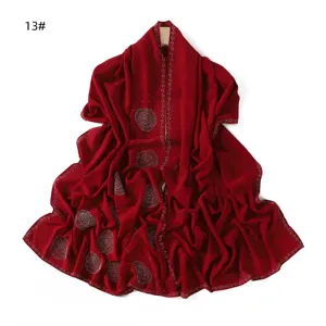 Detailed view of the elegant red chiffon rhinestone long scarf shawl, draped design.