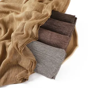 Detailed view of soft rayon crinkle scarf in earth tones, breathable texture and rolled edge.