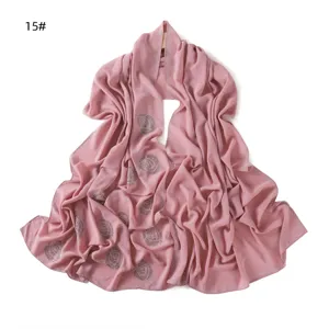 Chiffon scarf detail showing elegant pink color and sparkling rhinestone rose patterns for women.