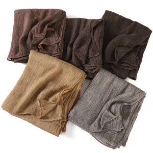 Detail shot of crinkled viscose long scarf set showcasing soft texture and rolled edges.