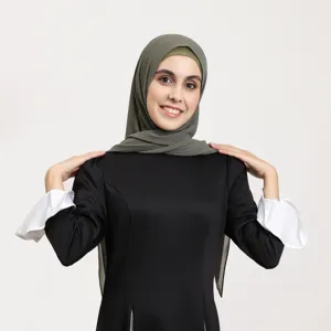 Detailed view of women elegant black dress paired with stylish grey hijab, premium fashion apparel.