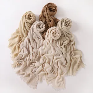 Detailed view of soft crinkle solid color long scarves with fringe edge in multiple shades.