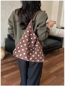Brown suede polka dot shoulder bag detail showcasing soft fabric and elegant vintage pattern.