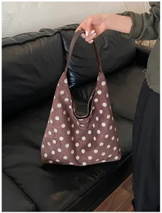 Brown polka dot suede shoulder bag detail showing soft texture and elegant vintage design style.