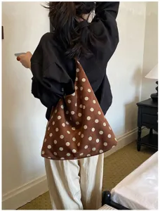 Close-up detail of the brown suede polka dot shoulder tote bag, stylish daily wear lifestyle.