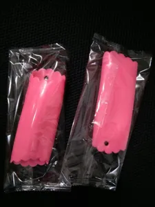 Close-up detail shot of the pink plastic garlic peeler tube with scalloped edge design.