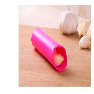 Silicone garlic peeler tube detail view, kitchen tool for quick and easy peeling, pink color.
