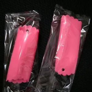 Silicone garlic peeler tube in pink color with wavy edge design, practical kitchen tool.