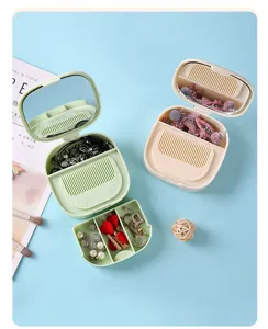 Multifunctional cosmetic mirror storage box with comb and drawer for jewelry and makeup.