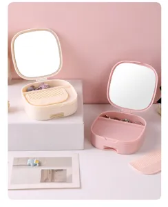 Portable makeup mirror jewelry storage box with comb and drawer for desktop dresser use.