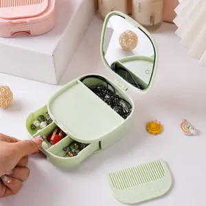 Multifunctional makeup mirror jewelry storage box with comb, desktop folding mirror and drawers.