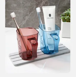 Transparent couple toothbrush cup set with handle and deer embossed design for home bathroom use.