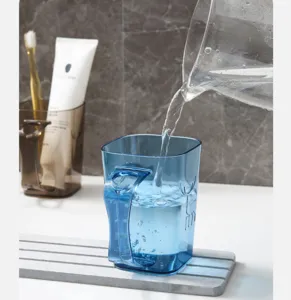 Clear mouthwash cup detail view showcasing its transparent blue texture and durable plastic material.