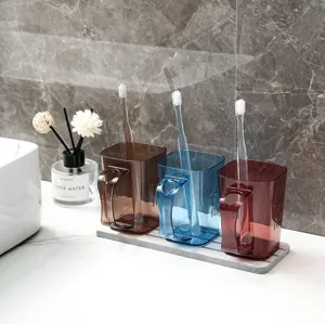 Transparent mouthwash cup set with tray, minimalist toothbrush holder for home use.