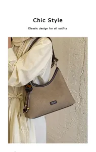 Retro canvas shoulder bag for women, chic hobo bag with contrast leather trim and tassel.