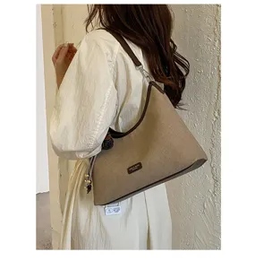 Vintage canvas shoulder bag for women, casual hobo underarm handbag with retro design.