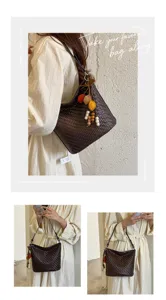 Detailed view of women's vintage woven shoulder bag with chic charms and strap.