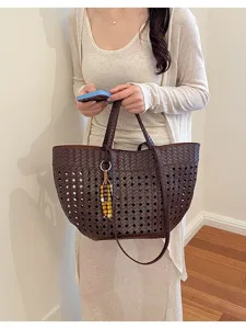 Detailed shot of dark brown woven leather tote bag, elegant cutout design, perfect for commute.