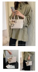 Chic woven dumpling handbag for women, elegant retro crossbody bag with cute pendant design.