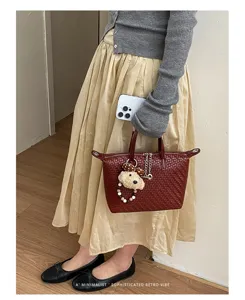 Elegant red woven handbag for women, stylish retro tote bag for daily commute and autumn fashion.