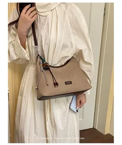 Chic retro canvas shoulder bag for women, stylish underarm hobo handbag with brown leather trim.