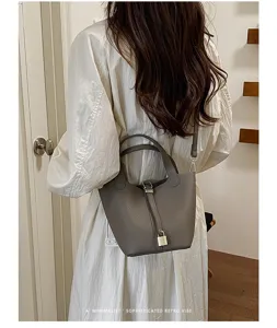 Detailed view of the stylish leather bucket handbag, elegant design with padlock accent.