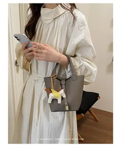 Stylish minimalist bucket handbag for women, premium leather tote bag with elegant charm.