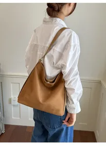 Brown faux suede shoulder bag for women, retro large capacity minimalist crossbody hobo bag detail.