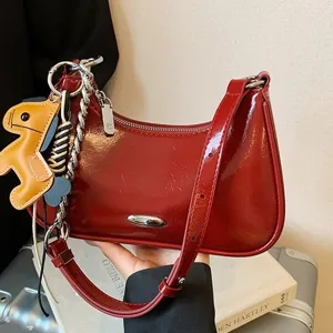 Borsa a spalla rossa in ecopelle verniciata da donna con catena elegante e ciondolo