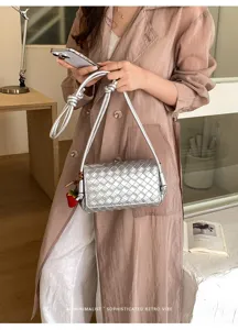 Detailed view of women silver woven shoulder bag, stylish casual crossbody purse with chic charm.