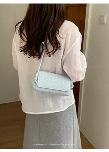 Woven underarm bag for women, stylish braided shoulder bag with minimalist retro vibe design.