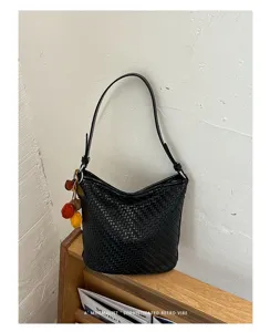 Classic black woven bucket bag for women, retro underarm shoulder bag with cute charms.